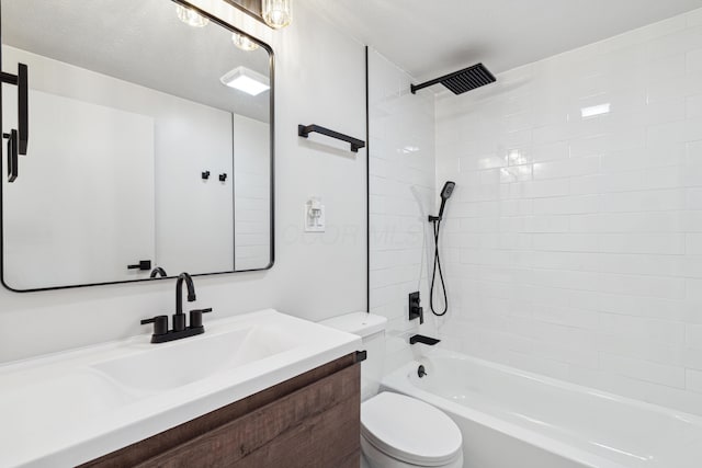 full bathroom featuring vanity, tiled shower / bath combo, a textured ceiling, and toilet