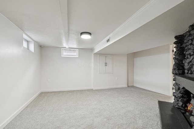 basement with carpet and a textured ceiling