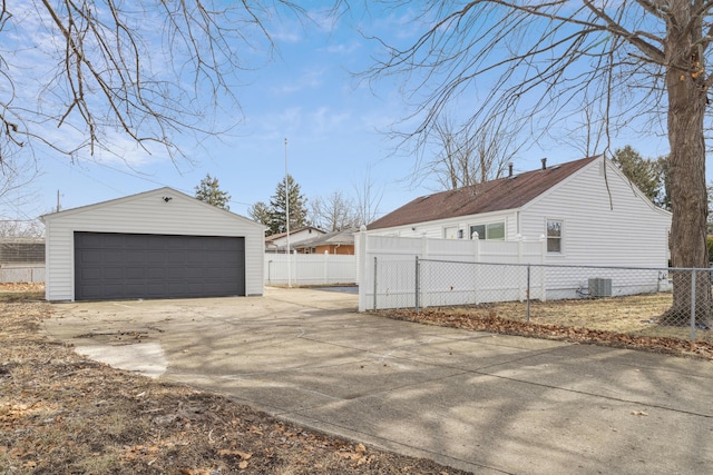 view of side of home with an outbuilding, a garage, and central AC