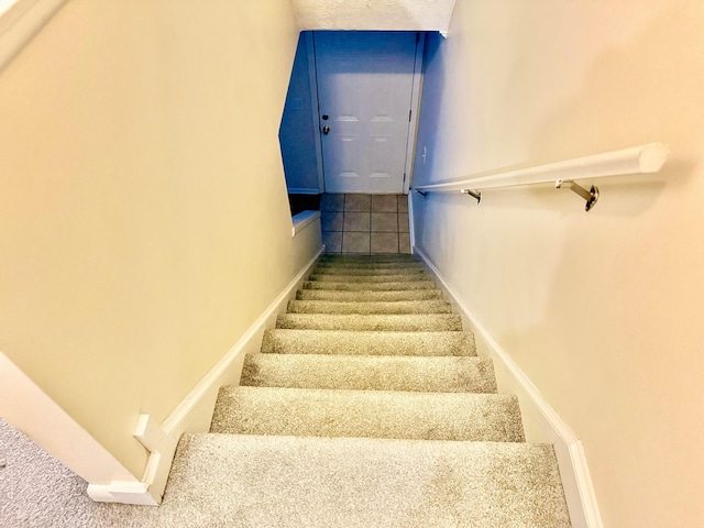 stairway featuring baseboards