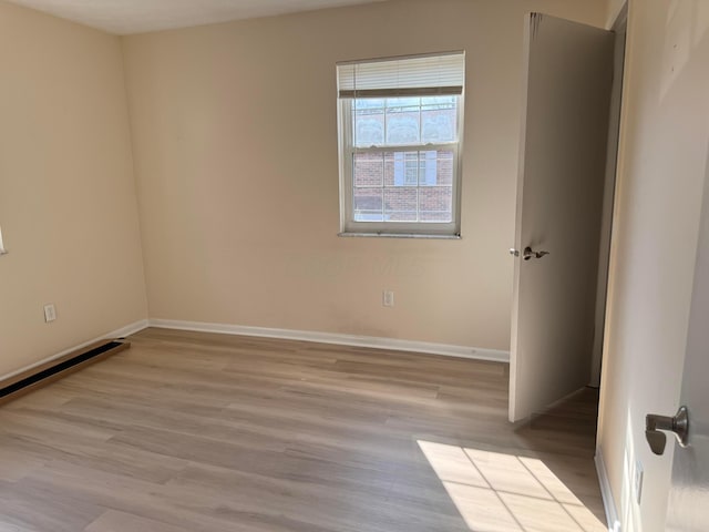 unfurnished room featuring wood finished floors and baseboards