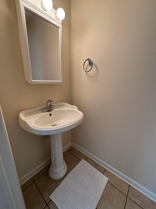 bathroom featuring tile patterned flooring and baseboards