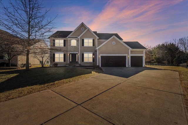 view of front of house featuring a garage and a lawn