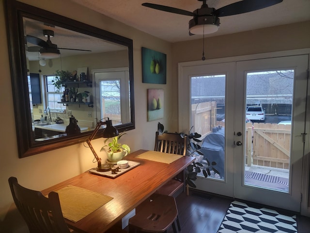 dining room with dark hardwood / wood-style flooring, sink, french doors, and ceiling fan