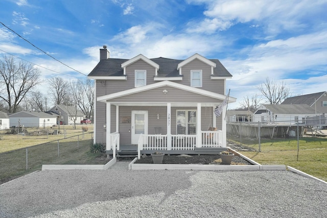 view of front of home with covered porch and a front lawn