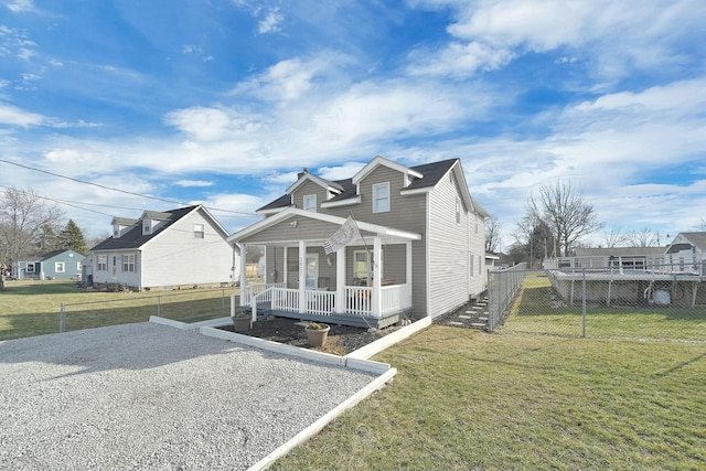 view of front of property with a porch and a front lawn