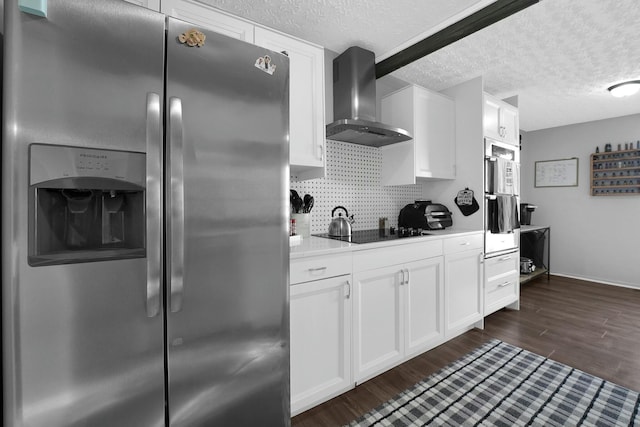 kitchen featuring dark hardwood / wood-style floors, white cabinets, stainless steel fridge, black electric cooktop, and wall chimney exhaust hood