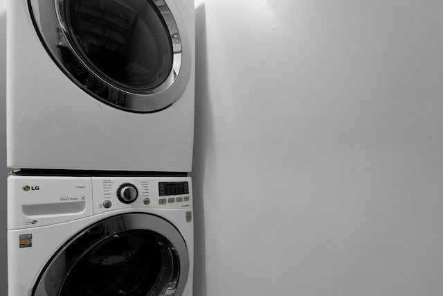 laundry area featuring stacked washer and dryer