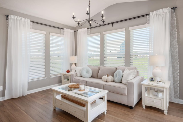 living room with hardwood / wood-style floors, a wealth of natural light, and vaulted ceiling