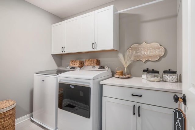 laundry room with cabinets and washing machine and dryer