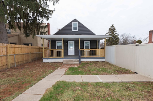 bungalow-style home with a porch and a front yard