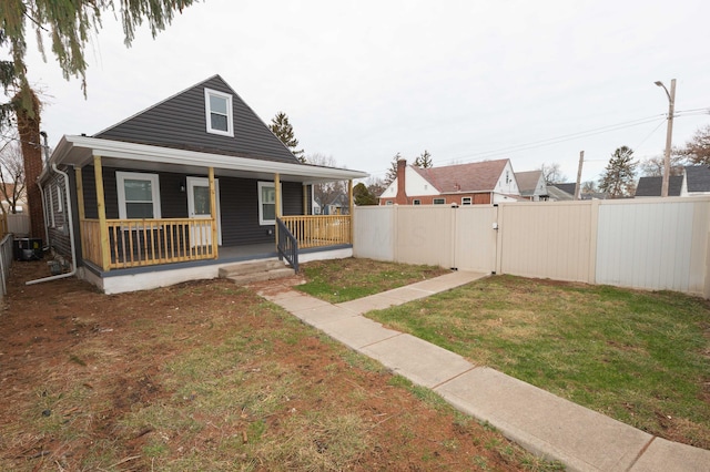 view of front of home featuring covered porch and a front lawn