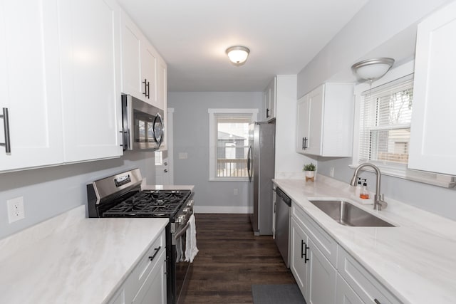 kitchen featuring sink, dark wood-type flooring, white cabinets, and appliances with stainless steel finishes