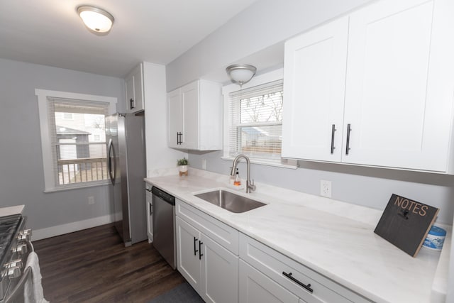 kitchen featuring white cabinetry, sink, stainless steel appliances, and a healthy amount of sunlight