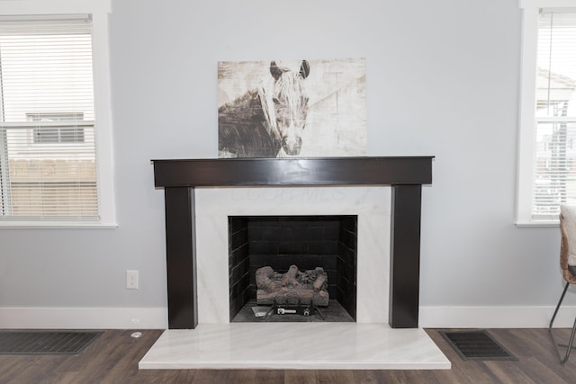 room details with hardwood / wood-style flooring and a high end fireplace