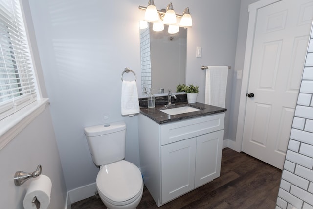 bathroom featuring vanity, wood-type flooring, a chandelier, and toilet