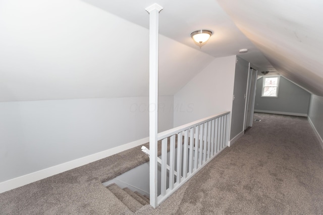 additional living space with vaulted ceiling and carpet floors