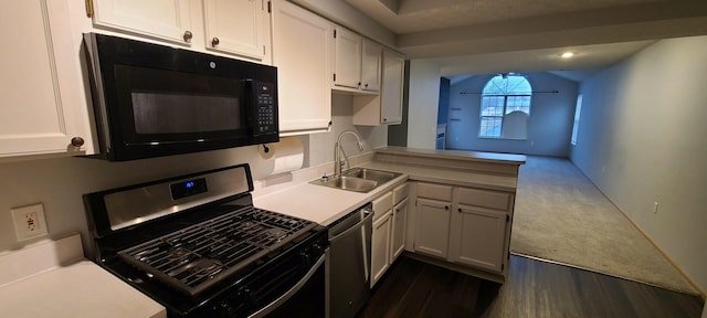 kitchen with dark wood-type flooring, sink, white cabinetry, appliances with stainless steel finishes, and kitchen peninsula