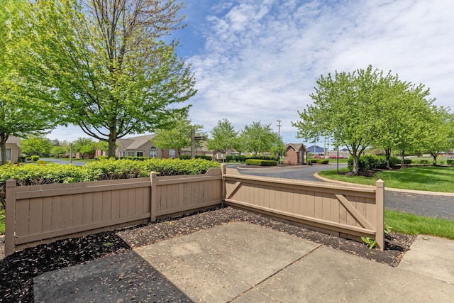 view of patio / terrace with fence and a residential view