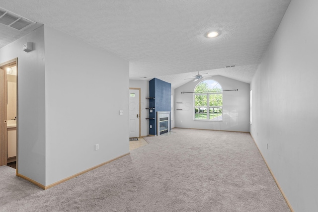 unfurnished living room with visible vents, ceiling fan, and light carpet