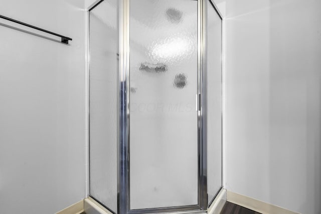 full bath featuring a shower stall