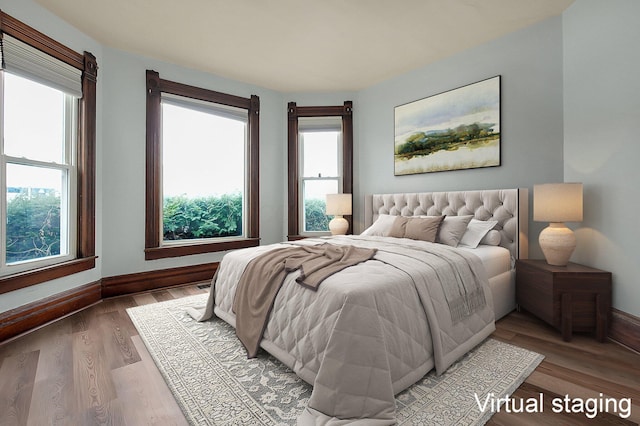 bedroom featuring hardwood / wood-style flooring and multiple windows