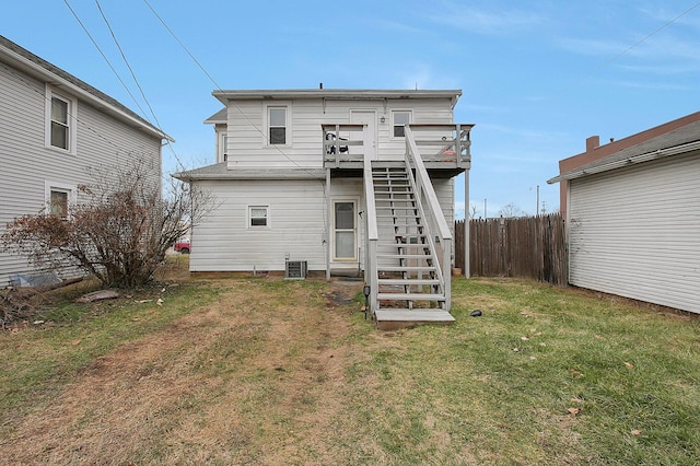 back of property featuring a lawn, central air condition unit, and a deck