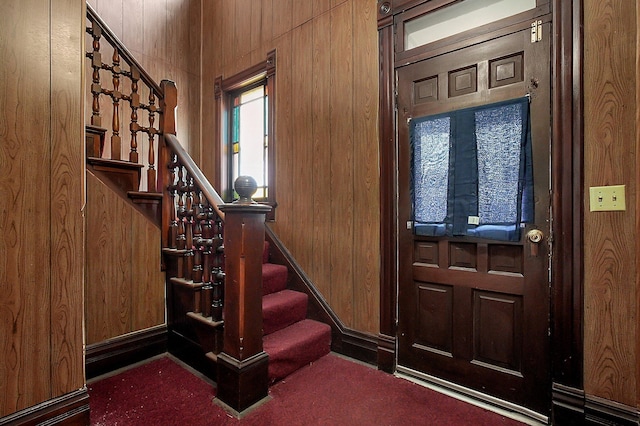 entryway featuring wooden walls