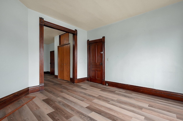 unfurnished room with light wood-type flooring