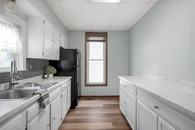 kitchen with white cabinetry, plenty of natural light, and sink