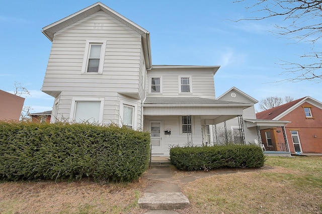 view of front of home featuring covered porch and a front yard