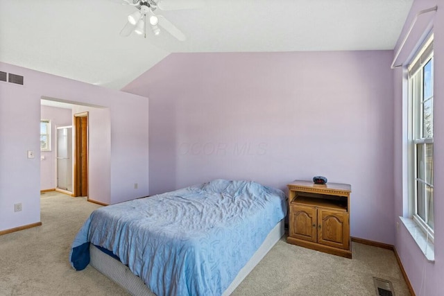 bedroom featuring light carpet, visible vents, and vaulted ceiling