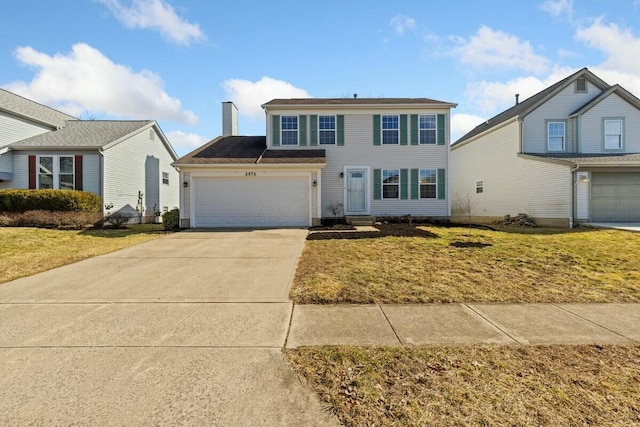 view of front of property featuring a garage, concrete driveway, a chimney, and a front lawn