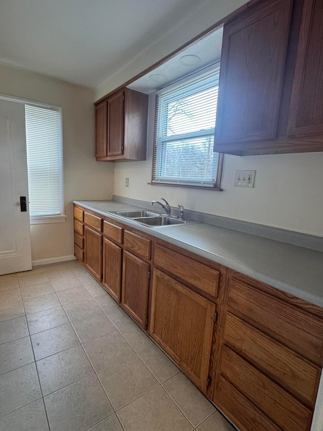 kitchen featuring light tile patterned flooring and sink