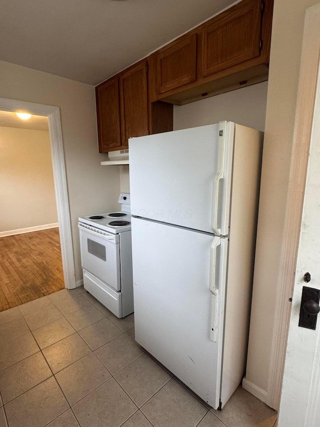 kitchen featuring white appliances and light tile patterned floors