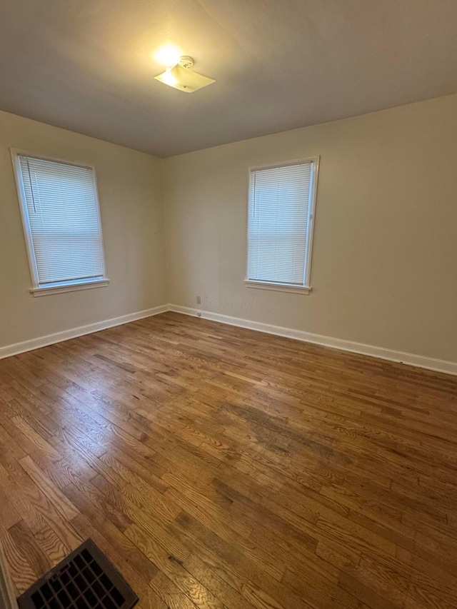 spare room featuring dark wood-type flooring