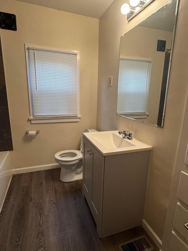 bathroom with vanity, hardwood / wood-style floors, and toilet