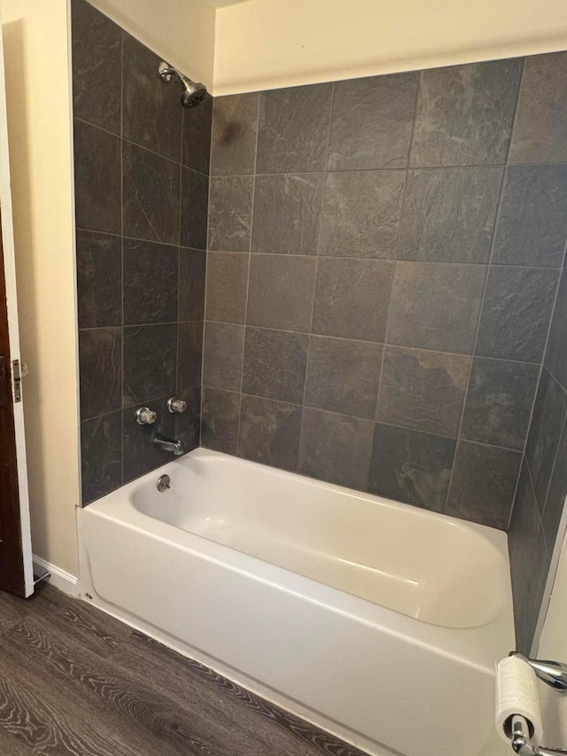 bathroom featuring hardwood / wood-style flooring and tiled shower / bath