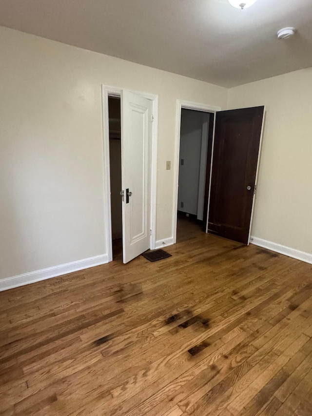 unfurnished bedroom with hardwood / wood-style floors