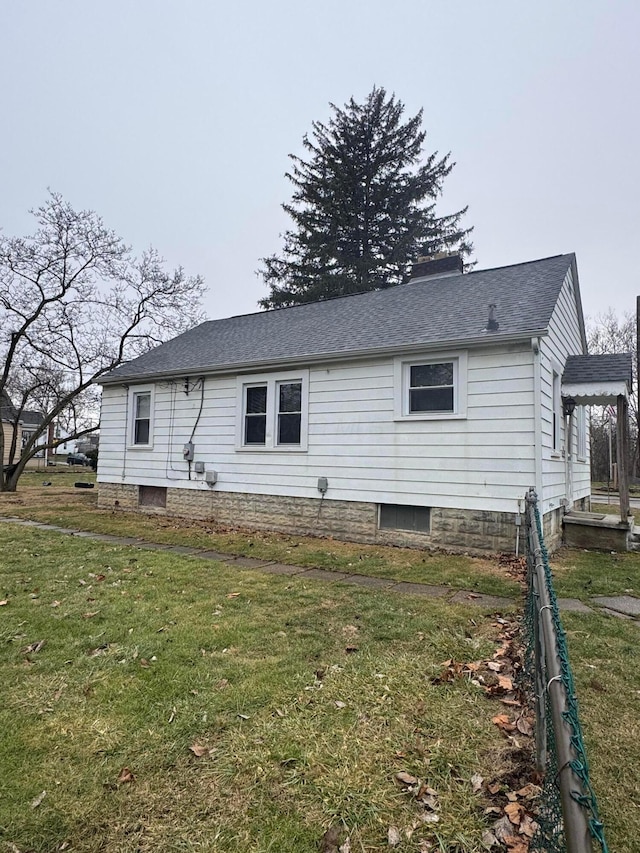 view of side of property featuring a yard