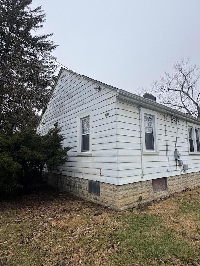 view of side of home featuring a yard