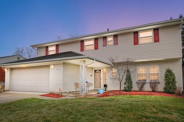 view of front of house with a garage and a lawn