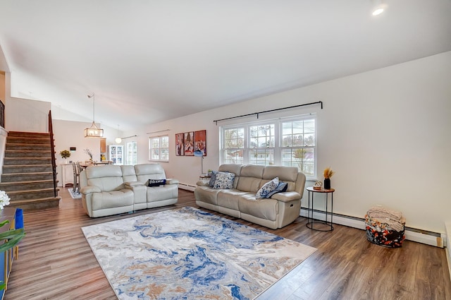 living room featuring hardwood / wood-style flooring, a baseboard radiator, and lofted ceiling