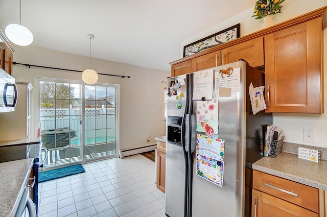 kitchen featuring light tile patterned flooring, pendant lighting, stainless steel fridge, and baseboard heating