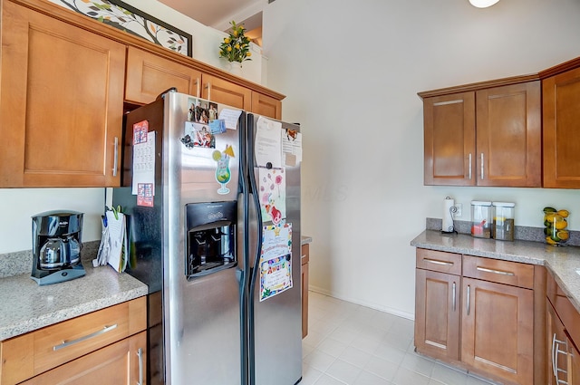 kitchen with stainless steel fridge and light stone counters