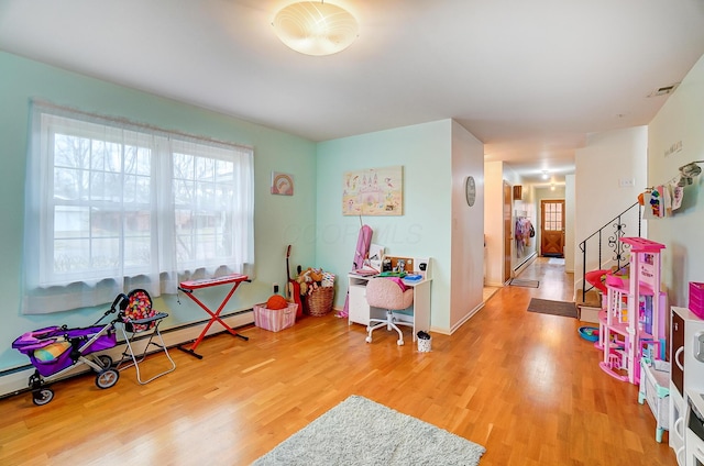 rec room featuring hardwood / wood-style flooring and baseboard heating