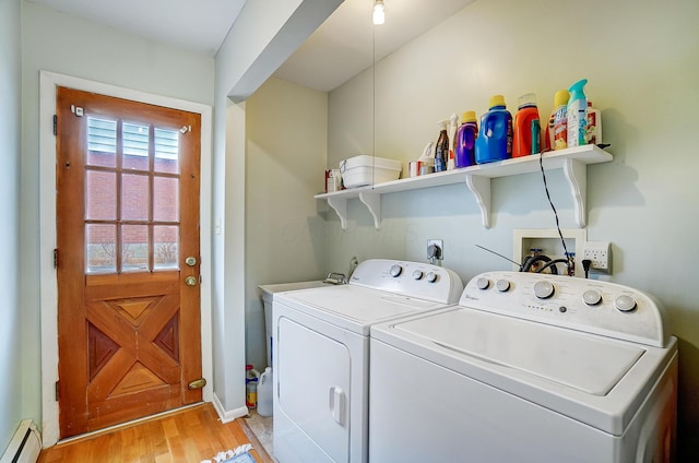 laundry area featuring light wood-type flooring, washer and dryer, and a baseboard heating unit