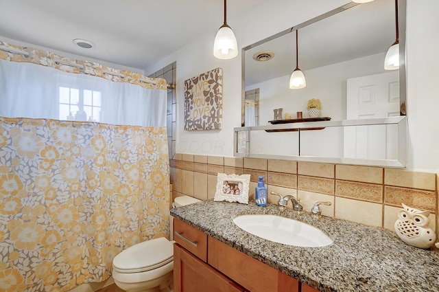 bathroom featuring tile walls, vanity, curtained shower, and toilet