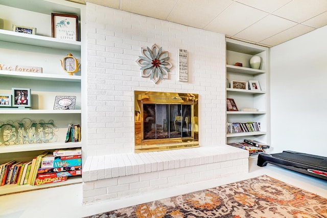 interior space featuring a brick fireplace and built in features