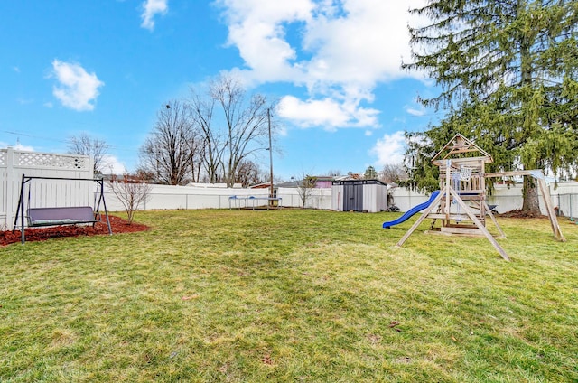 view of yard featuring a storage shed and a playground